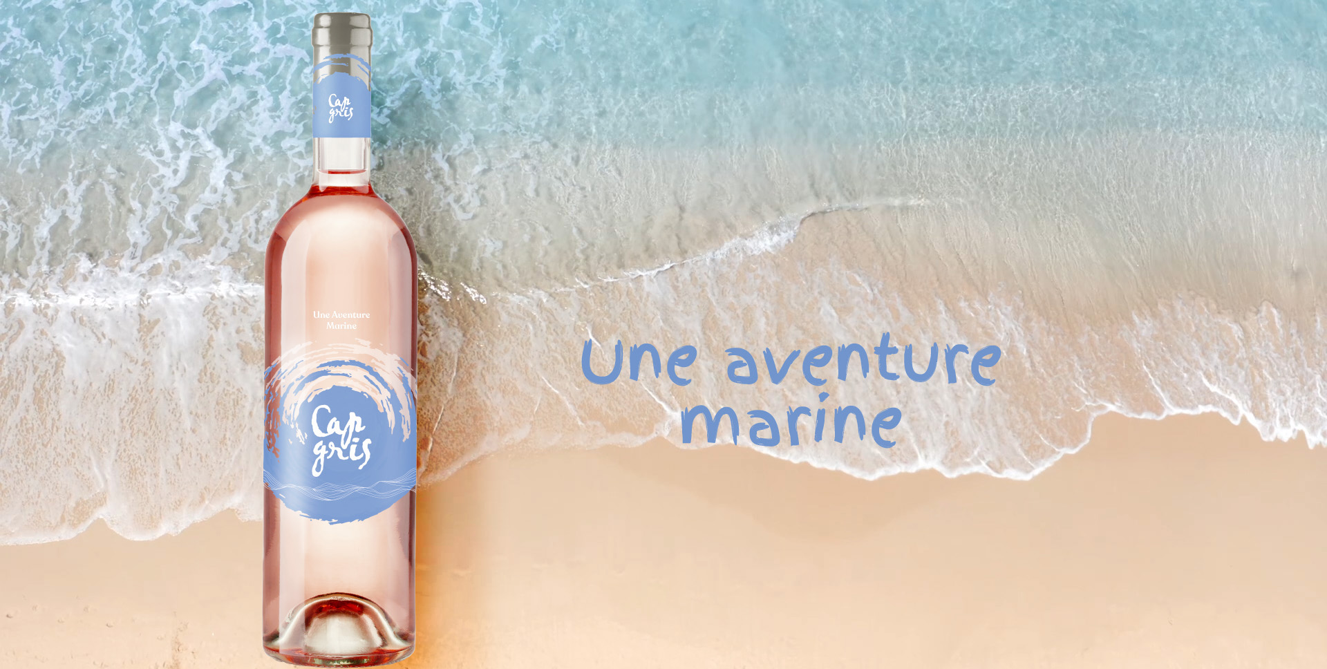 Cap Gris rosé bottle on the beach with the tagline une aventure marine, relaunch by Supermoon