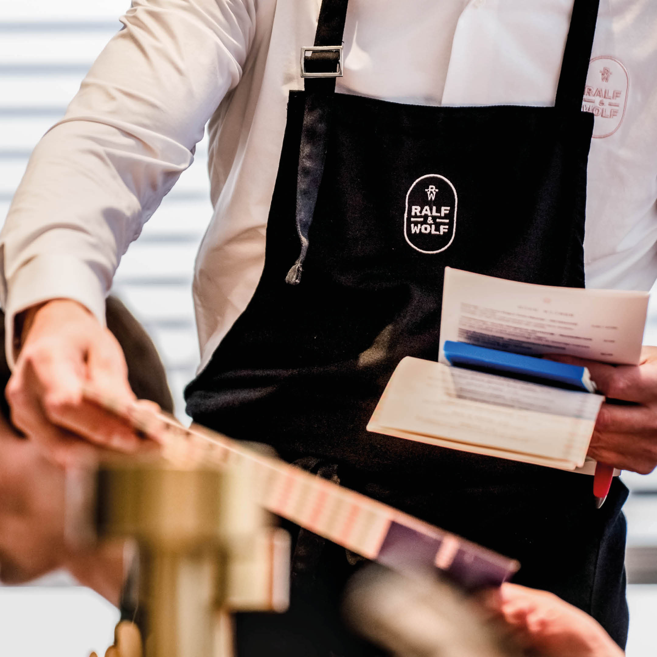 Ralf & Wolf branded apron and menu