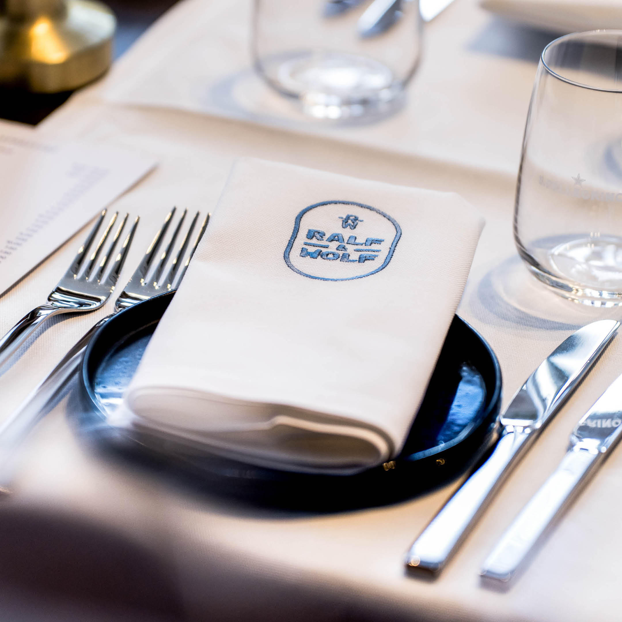 Ralf & Wolf table setting with branded napkin