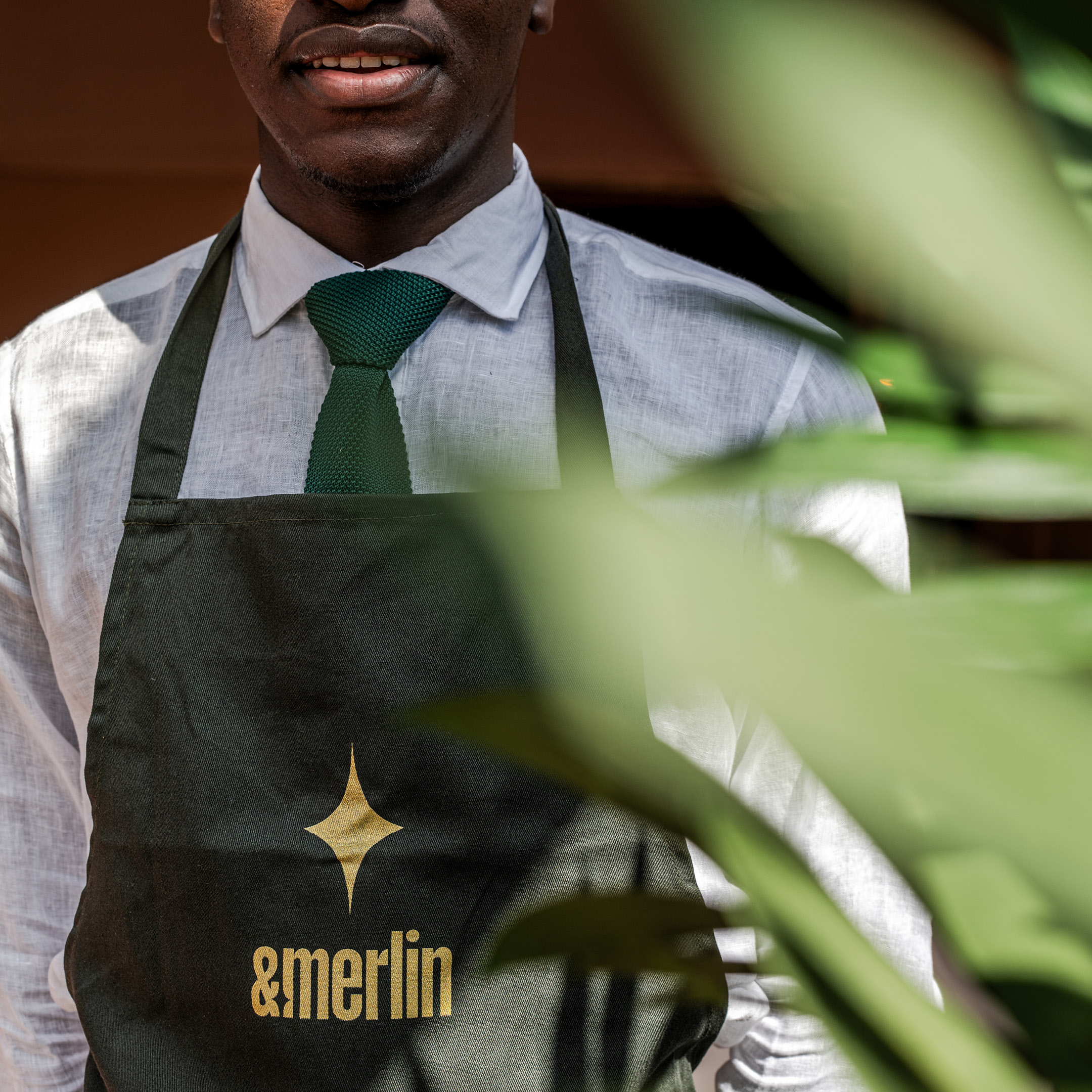 &merlin staff member wearing a branded apron