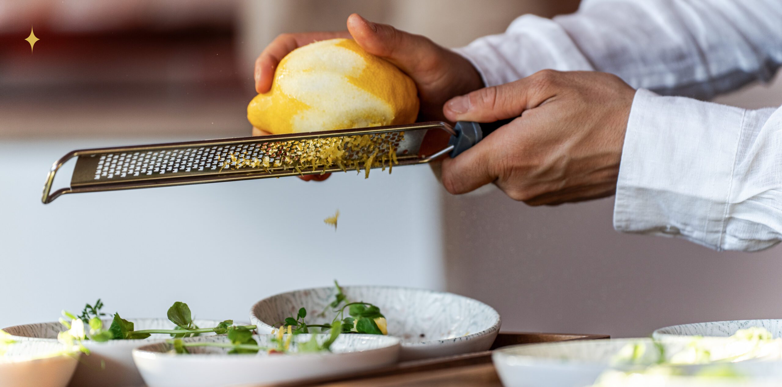 Chef zesting a lemon, &merlin event photography