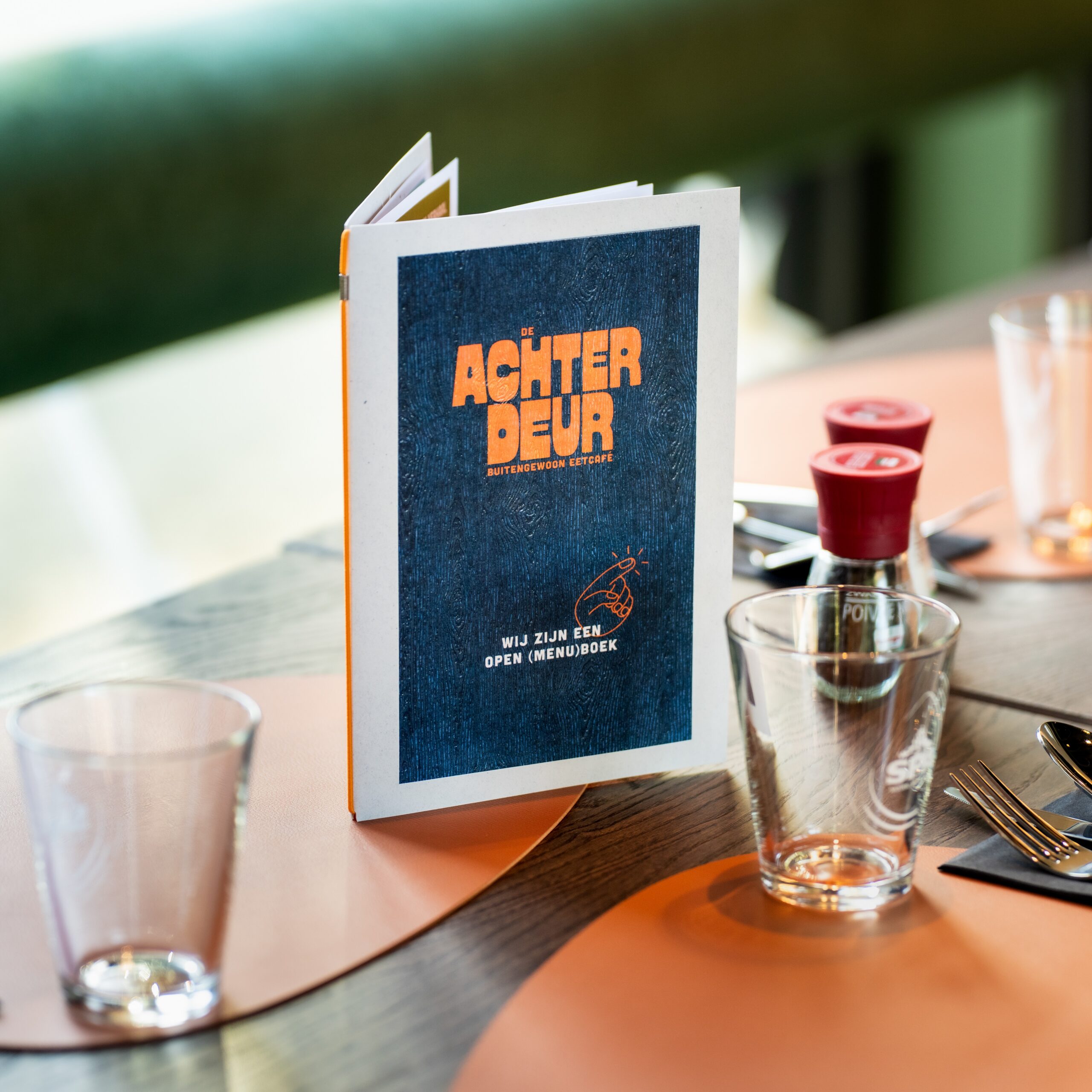De Achterdeur menu design on a restaurant table