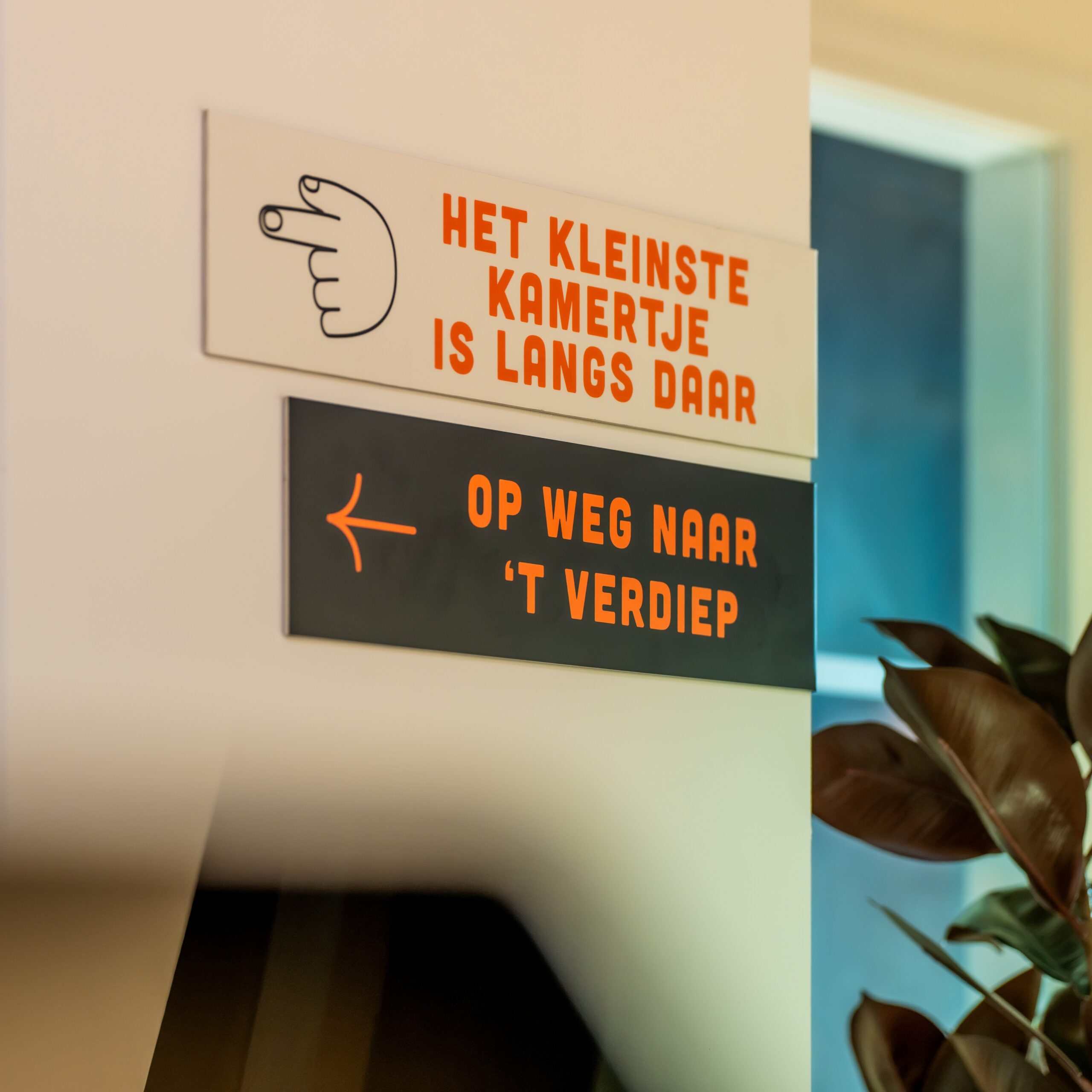 De Achterdeur wayfinding signage with playful copy